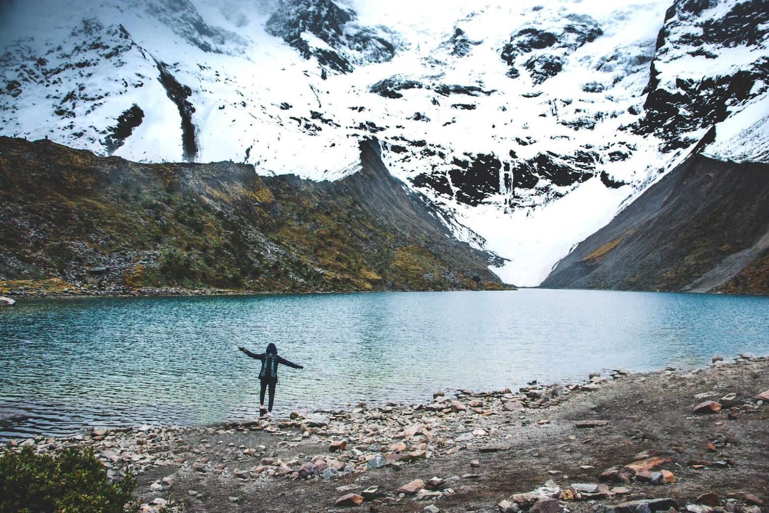 person standing near lake at daytime